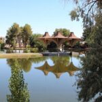 Craig Dietrich / Wikimedia Commons Alt-Text: Central Park in California city with a lake and trees around it and reflections in the lake