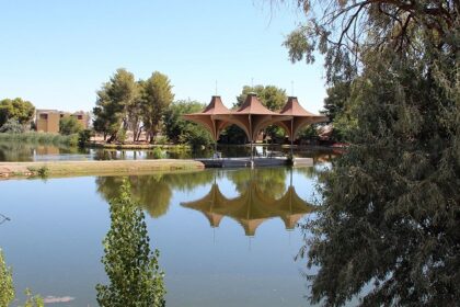 Craig Dietrich / Wikimedia Commons Alt-Text: Central Park in California city with a lake and trees around it and reflections in the lake