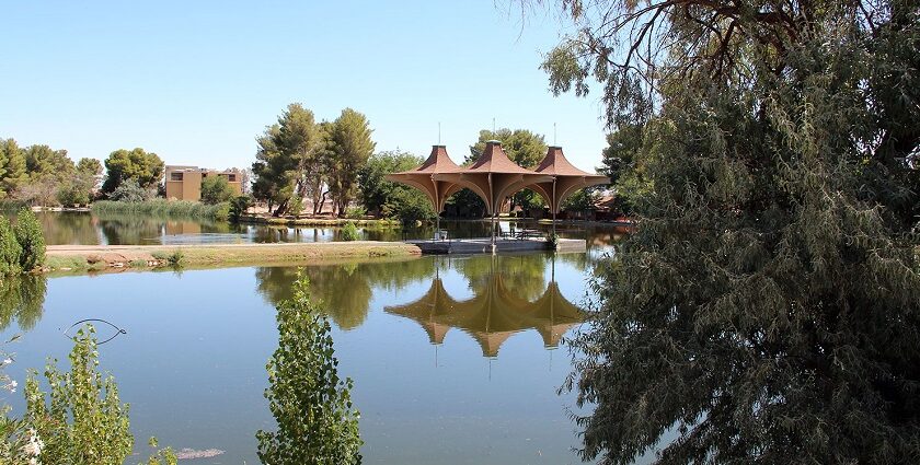 Craig Dietrich / Wikimedia Commons Alt-Text: Central Park in California city with a lake and trees around it and reflections in the lake