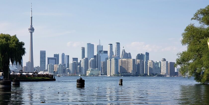 Canada city skyline view across a water body and many skyscrapers including the CN Tower