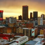 A beautiful view of the stunning Johannesburg skyline and a train in the foreground.