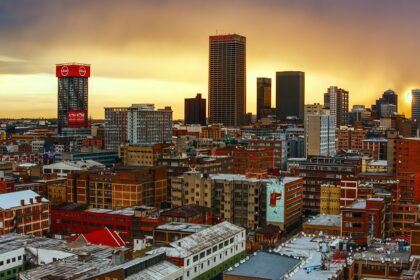 A beautiful view of the stunning Johannesburg skyline and a train in the foreground.