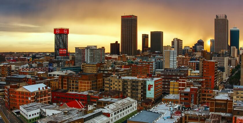 A beautiful view of the stunning Johannesburg skyline and a train in the foreground.