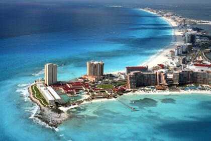 Aerial view of an island that has large buildings and housing areas surrounded by water