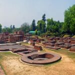 A scenic view of an ancient archaeological site in Sarnath, a Buddhist pilgrimage site.