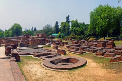 A scenic view of an ancient archaeological site in Sarnath, a Buddhist pilgrimage site.