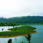 A picture of a serene lake, showcasing some of the top places to visit in Valparai.