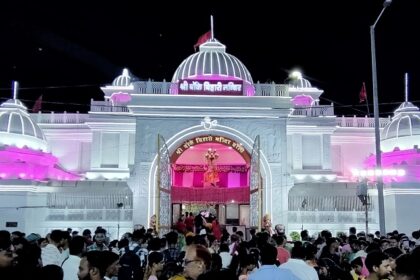 A frontal view of the Banke Bihari temple decorated with lights during nighttime