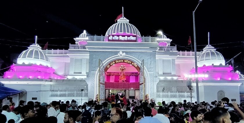 A frontal view of the Banke Bihari temple decorated with lights during nighttime