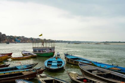 A picture of Muzaffarnagar - boats floating on the lake showcasing tranquility.