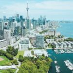 A distant view of the Toronto skyline showcasing the buildings across the water body.