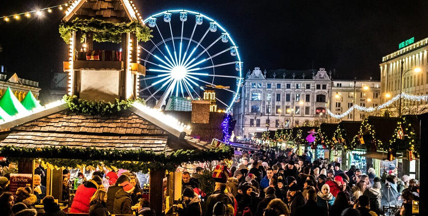 Amusement park in Poland with a crowd of people, a Ferris wheel, eateries and shops