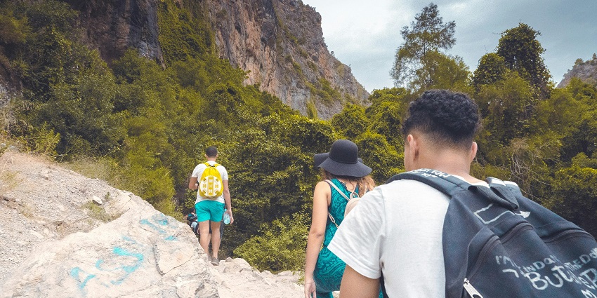 An image of trekkers climbing a steep trail to reach Prabalgad Fort amidst greenery.