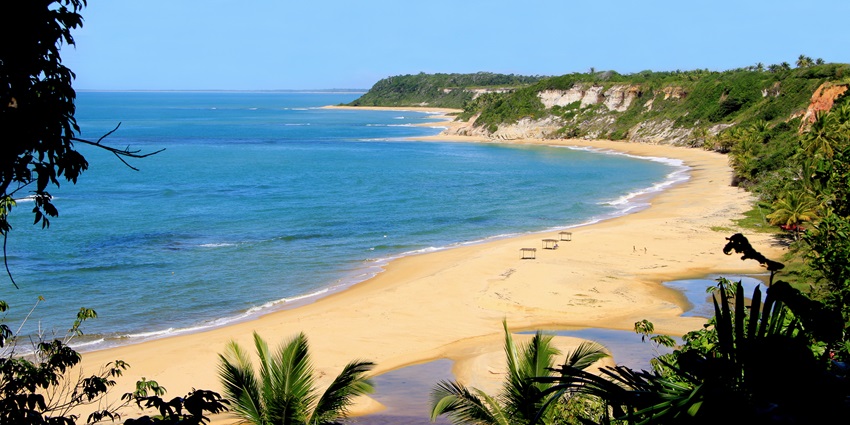Surrounded by cliffs and vegetation, you must visit this famous Brazil Beach