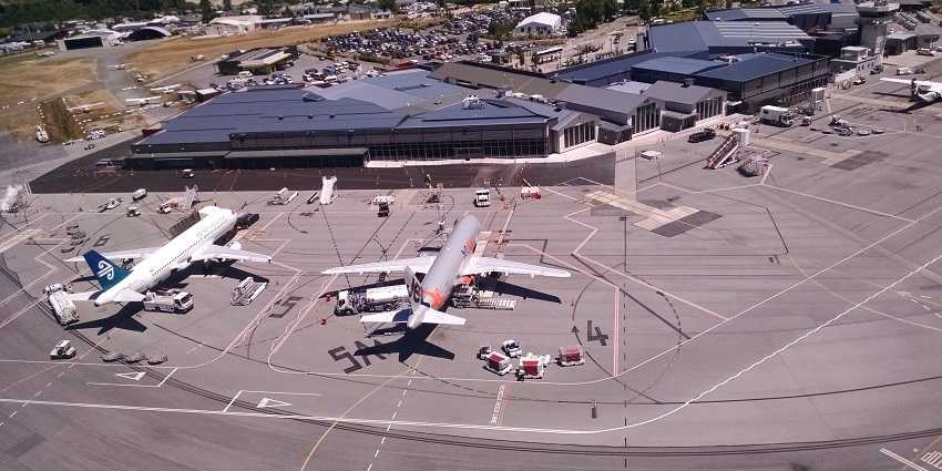 Queenstown Airport in New Zealand welcomes visitors with stunning mountain views.