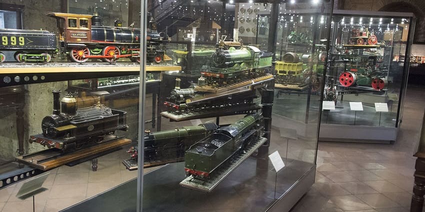 Industrial museum with vintage cars, machinery, and engineering exhibits.