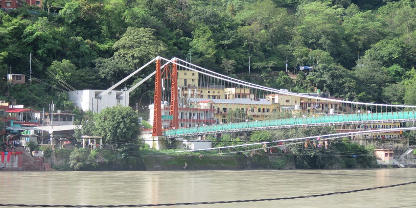 The famous Ram Jhula in Rishikesh is an iron suspension bridge that spans the sacred Ganga.