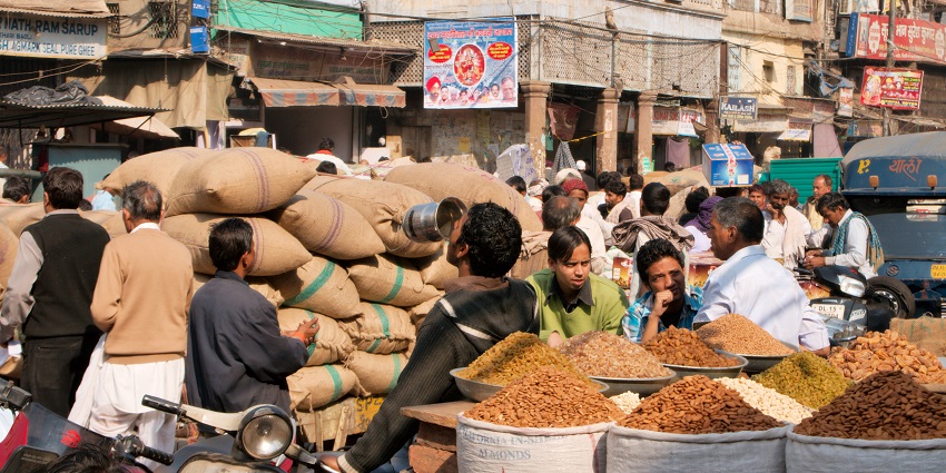 Lively market with diverse products, including clothes and groceries.