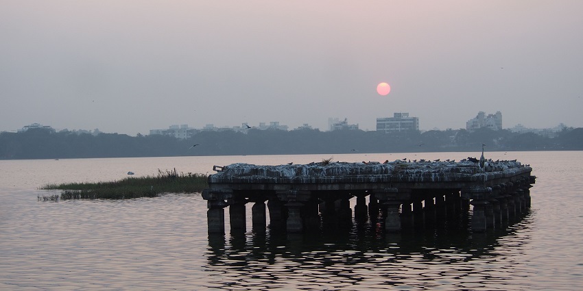 A beautiful view of a man enjoying the sunset at Rankala Lake–a wonderful place.