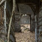 Ancient ruins of Redi Fort with crumbling stone walls surrounded by lush greenery