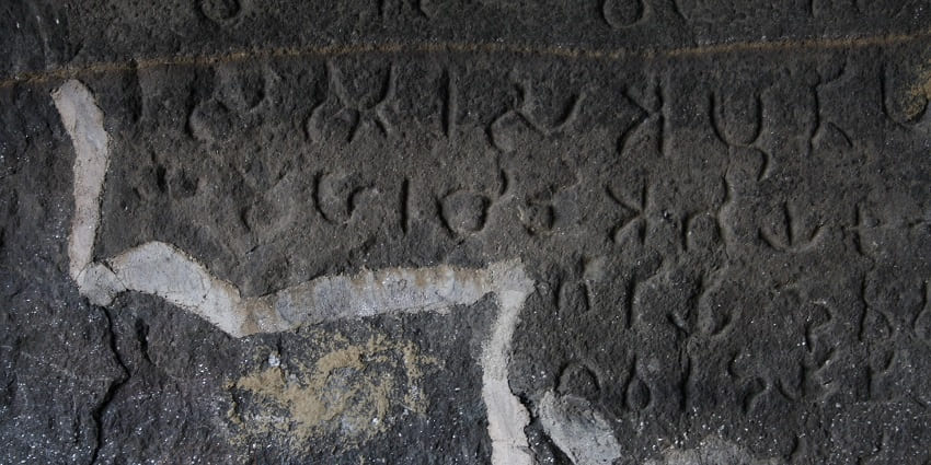 An image of ancient carvings and inscriptions found in the caves of Naneghat.