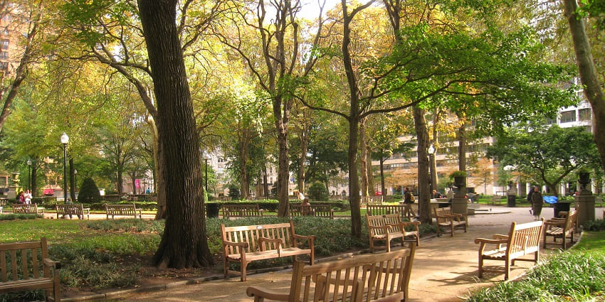 Rittenhouse park with benches lined on the sides, one of the things to do in Philadelphia.