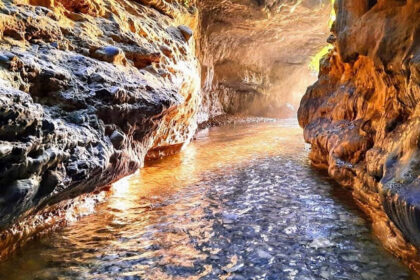 A beautiful picture of the Robbers Cave with a narrow gorge and streams.