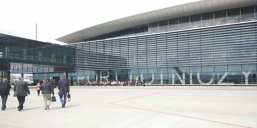Rzeszów-Jasionka Airport with glass, modern architecture and people sitting in the line