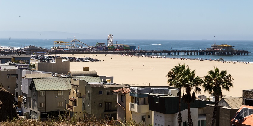 An image of Point Dume Beach in winter, featuring a lifeguard tower, sandy shores, and gentle waves.