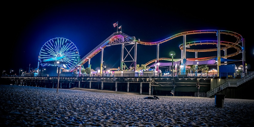The amusement park at Santa Monica Pier as seen in the nighttime showing lit-up rides