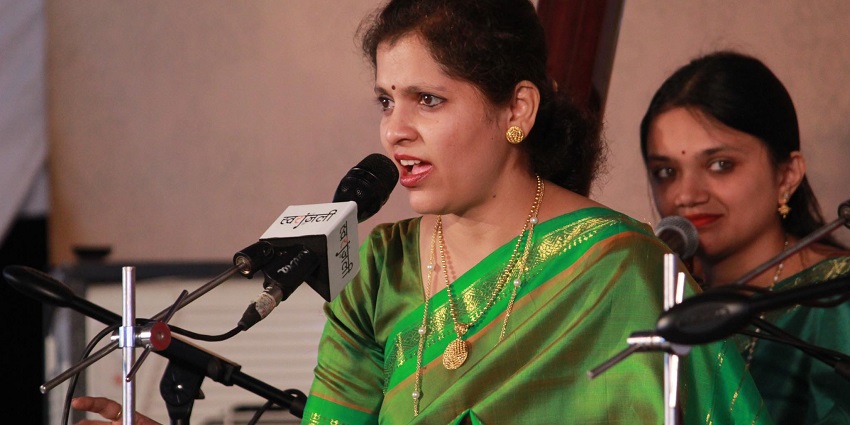 A traditional music festival in Pune with a female vocalist performing live