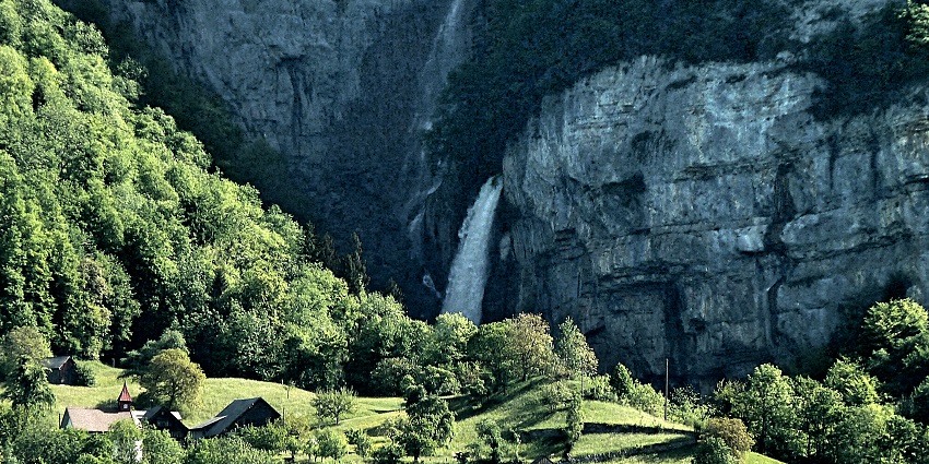 Triple waterfall offering dramatic cascades and picturesque cliffside backdrop.