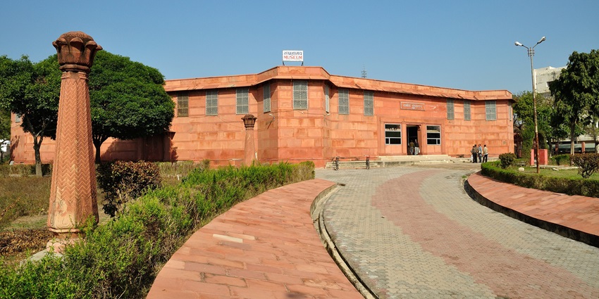 Government Museum Mathura building façade with stone carvings and surrounding trees