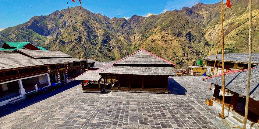 An image of Shivshakti Dham with a multi-coloured temple rooftop and a temple.