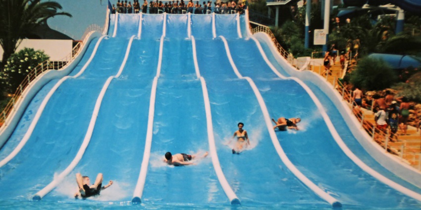 An image of people can be seen riding the slides of a water parks in Greater Noida on a sunny day.
