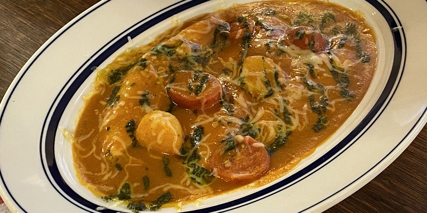 An image of a delicious French fish soup served with garlic toast and rouille.