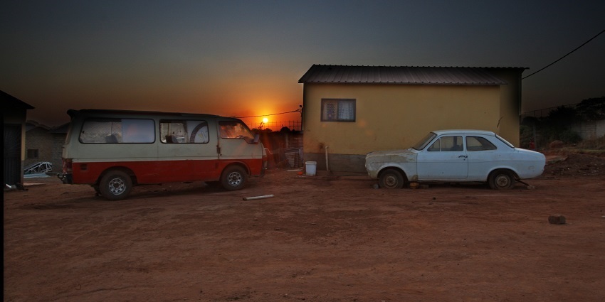 Beautiful view of a sunset at Soweto city with a vehicle standing in front