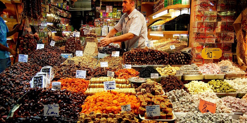 Vibrant market offering aromatic spices, sweets, and local products.