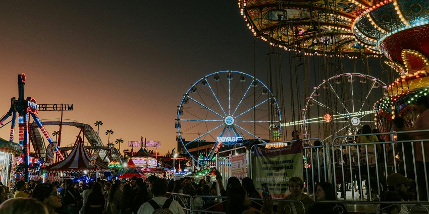 The image of a crowd at an amusement park in Canada on rides and creating an exciting atmosphere.