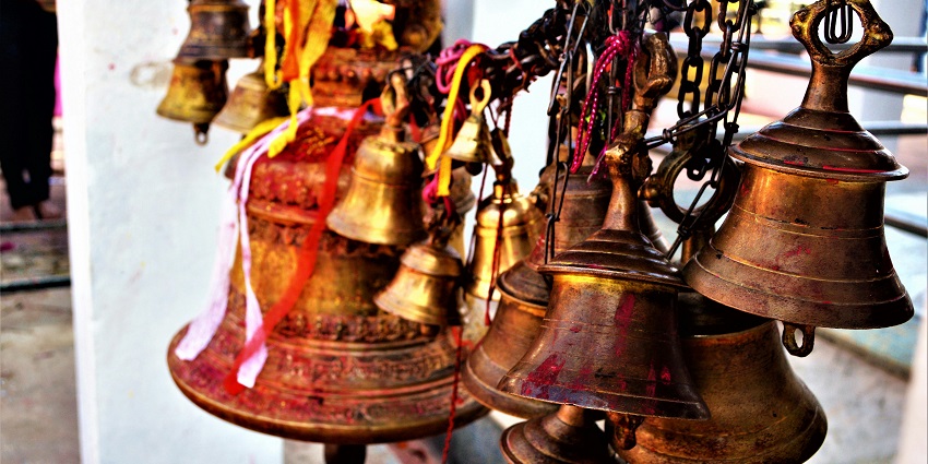 Image of temple bells hanging together, showcasing cultural significance in Sri Guruvayurappan Temple