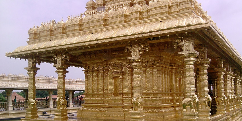 A group of people standing in front of a Sri Lakshmi Narayani Golden Temple.