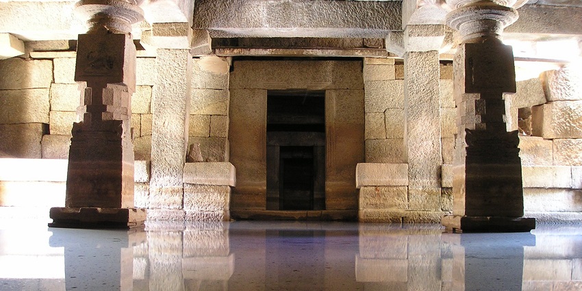 The image shows a beautiful temple reflected in the calm water under a clear sky