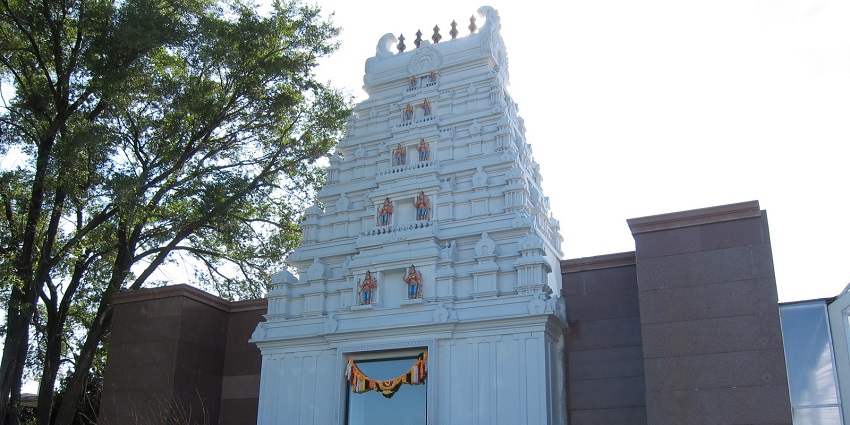 A view of one of the temples in Toronto features a tall, intricately designed entrance tower.