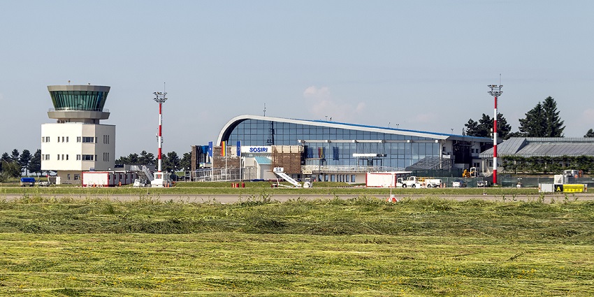Suceava International Airport area with modern glass architecture and tall tower lights