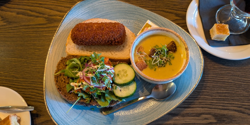 A picture of a typical Dutch meal consisting of soup, salad, and bread served at a restaurant in Amsterdam