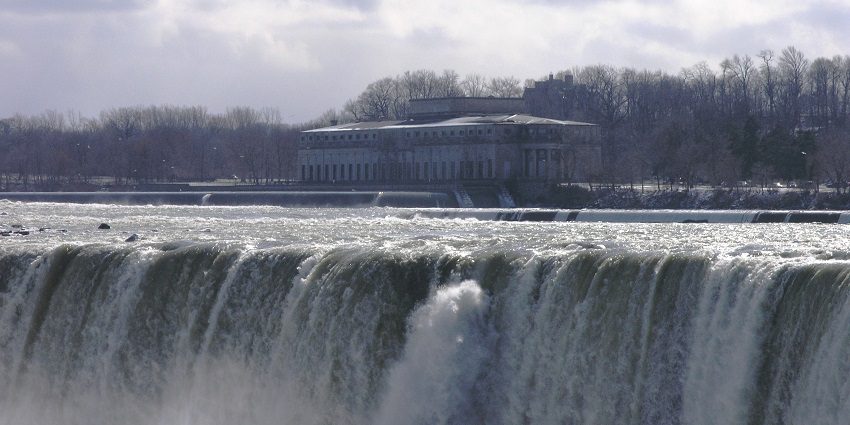 A view of Horseshoe Falls with a building in the background in Ontario, Canada.