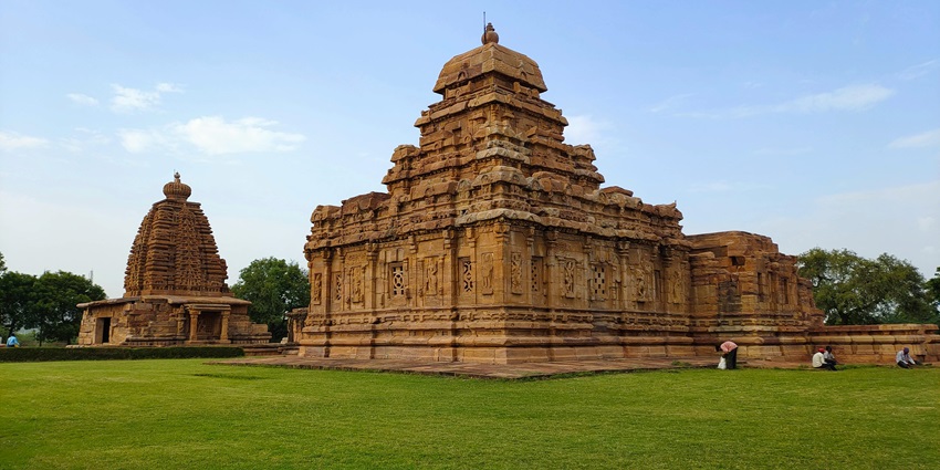 Beautiful temple amidst the lush green landscape under the sunny blue sky