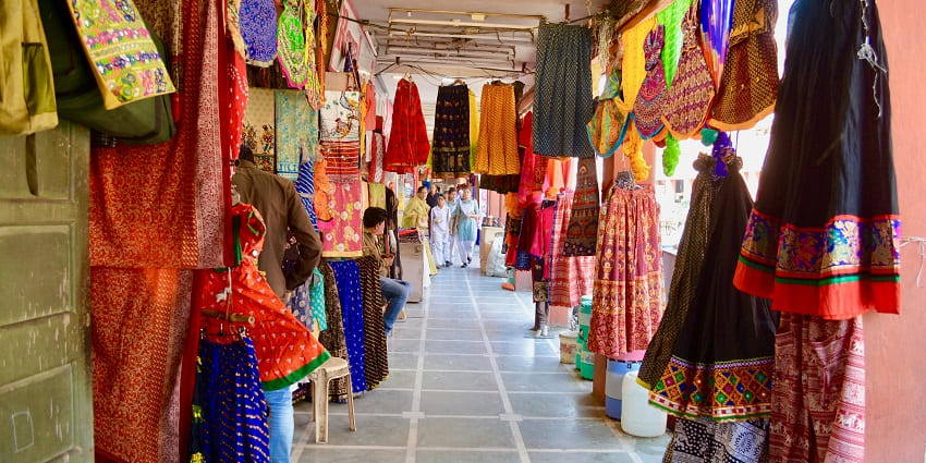 Busy marketplace with handicrafts, clothes, and local specialities.