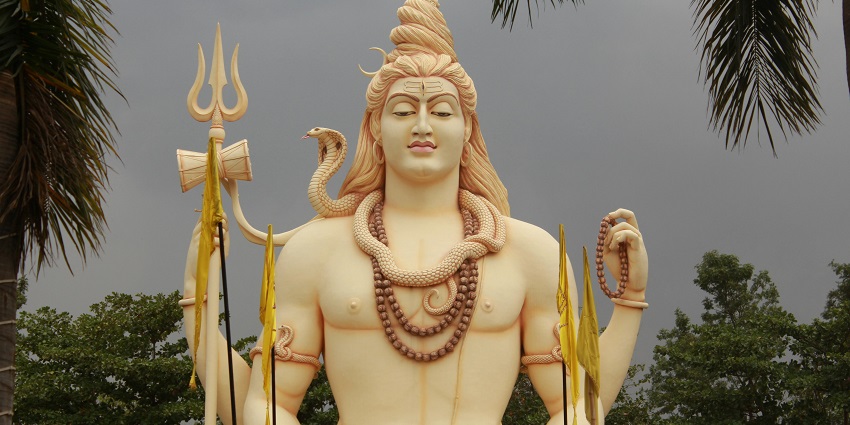 Image of idol Lord Shiva with beautiful colour coded statue - surrounded by lush greenery