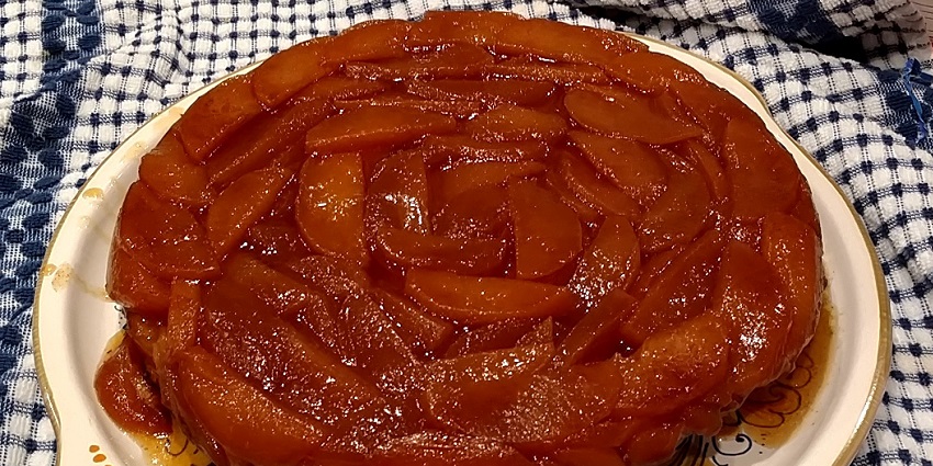 An image of a caramelized apple tart served warm, a French dessert classic.